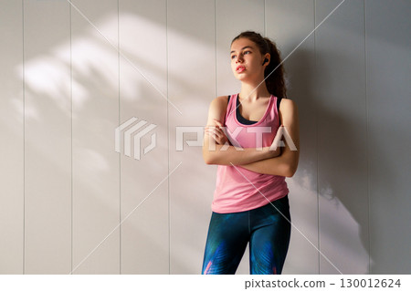 Woman in fashionable sportswear is doing exercise. Woman in fashionable sportswear is doing exercise. 130012624