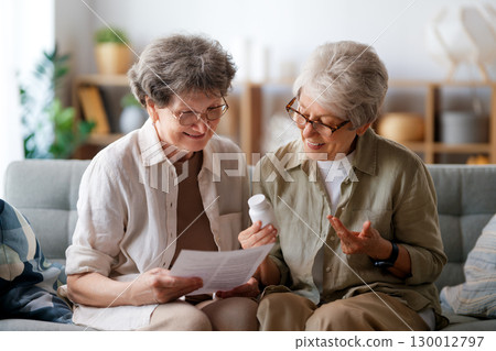 women are taking medication at home 130012797