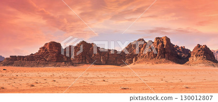 Planet Mars like landscape - Photo of Wadi Rum desert in Jordan with red pink sky above, this location was used as set for many science fiction movies 130012807