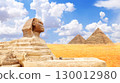 Horizontal banner with Sphinx and pyramid of Chephren and Cheops, Cairo, Egypt. Topic of travel, trip abroad on vacation, cruises and tours. Great Pyramids and statue of Sphinx, Giza Necropolis 130012980