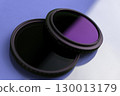 Two camera lens filters with reflections on a blue surface 130013179