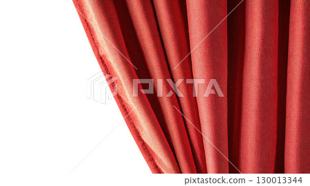 Soft red fabric drapes elegantly from a curtain rod in a cozy interior setting 130013344