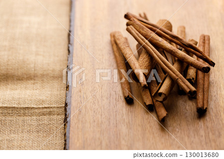 Cinnamon sticks dried tree bark spice on rustic wooden table background. 130013680
