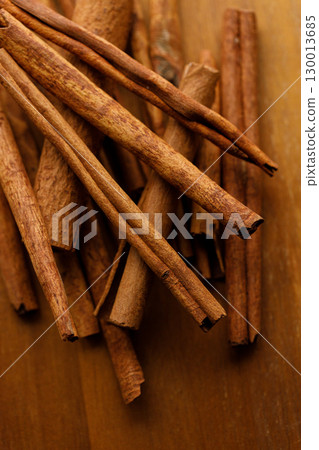 Cinnamon sticks dried tree bark spice on rustic wooden table background. 130013685
