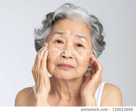 AI-generated image of an elderly woman concerned about wrinkles AI-generated image of an elderly woman concerned about wrinkles 130013689