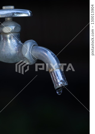 Water drops falling from the faucet 130013904