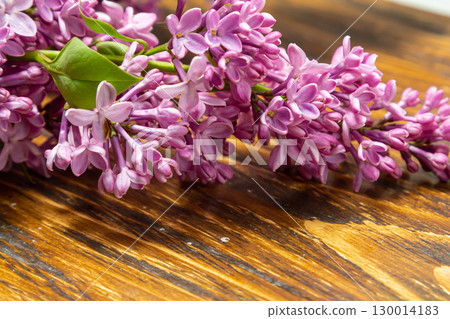 Beautiful spring flowers lilac on a wooden vintage board with place for text. Syringa vulgaris. Happy Mother's Day greetings card. Beautiful spring flowers lilac on a wooden vintage board with place for text. Syringa vulgaris. Happy Mother's Day greetings card. 130014183