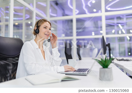 Young caucasian woman working on a laptop in the office Young caucasian woman working on a laptop in the office 130015060