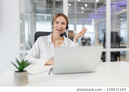 Young confident business woman having a call and looking involved Young confident business woman having a call and looking involved 130015104