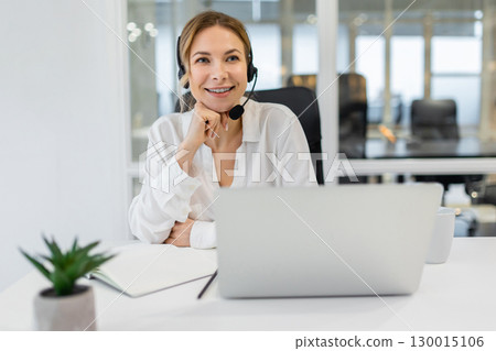 Young confident business woman having a call and looking involved 130015106