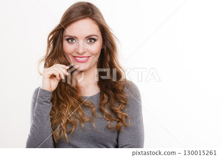 Portrait of happy attractive woman wearing grey top Portrait of happy attractive woman wearing grey top 130015261