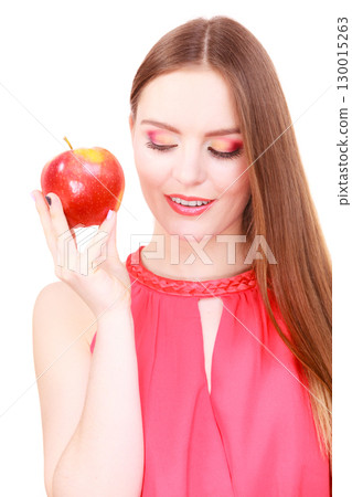 Woman charming girl colorful makeup holds apple fruit Woman charming girl colorful makeup holds apple fruit 130015263