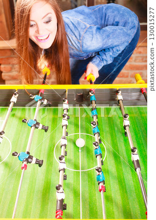 woman playing table football game 130015277