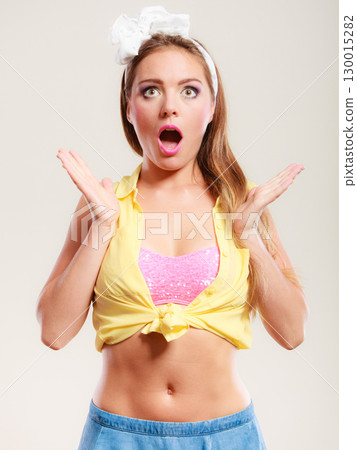 Amazed surprised pin up girl with mouth wide open. 130015282
