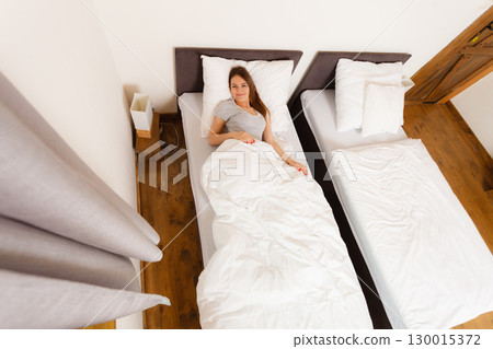 Beautiful woman lying on the bed. 130015372