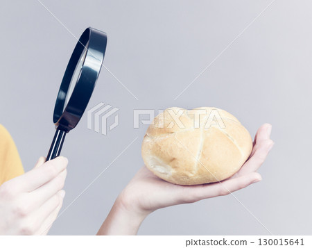 Bun bread roll and magnifying glass Bun bread roll and magnifying glass 130015641
