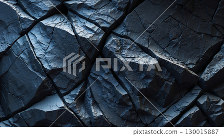 Fractured dark rock face forming dramatic natural background Fractured dark rock face forming dramatic natural background 130015887