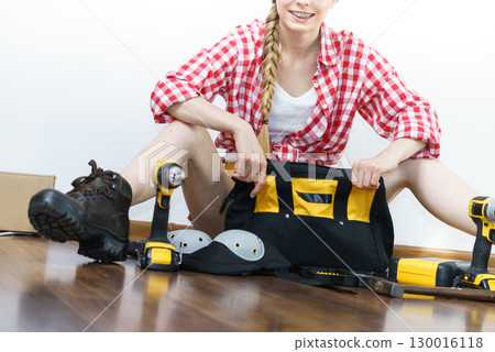 Woman constructive worker with tool bag Woman constructive worker with tool bag 130016118