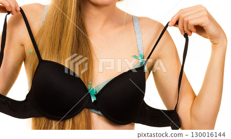 Woman choosing bra to wear Woman choosing bra to wear 130016144