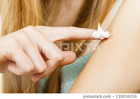 Woman apply moisturizer cream on her body 130016150