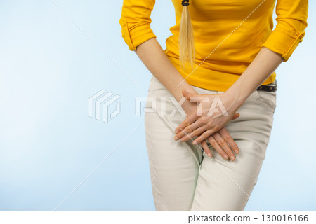 Woman with hands holding her crotch Woman with hands holding her crotch 130016166