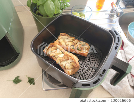 Bruschetta with porcini mushrooms and cheese. Food and quality products cooked in aero fryer. Traditional cuisine of Italy. Bruschetta with porcini mushrooms and cheese. Food and quality products cooked in aero fryer. Traditional cuisine of Italy. 130016606