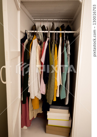 Women clothing on hangers in a real built-in wall cabinet 130016703