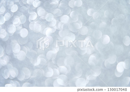 Abstract silver bokeh lights on soft gray background with circular blurred 130017048