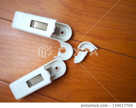 Aerial view of a clothespin that has broken due to aging (facing right, left aligned) 130017708