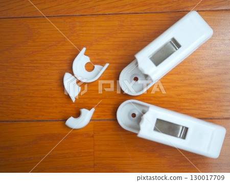 Aerial view of a clothespin that has broken due to aging (facing left, right-justified) 130017709