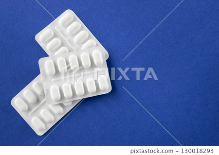 Much medical pills and drugs in white package on the blue background. Healthcare concept. Space for text. 130018293