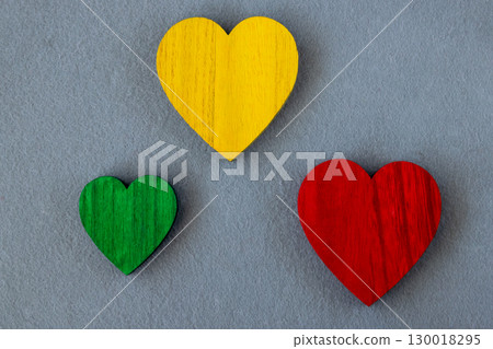 Traffic light colors wood hearts on the gray fabric background. Romantic greeting card. 130018295