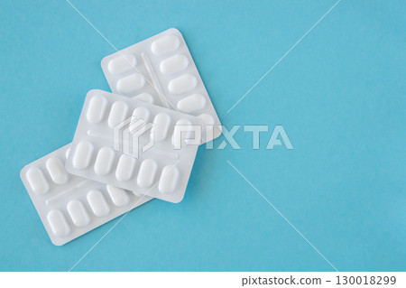Much medical pills and drugs in white package on the blue background. Healthcare concept. Space for text. Much medical pills and drugs in white package on the blue background. Healthcare concept. Space for text. 130018299