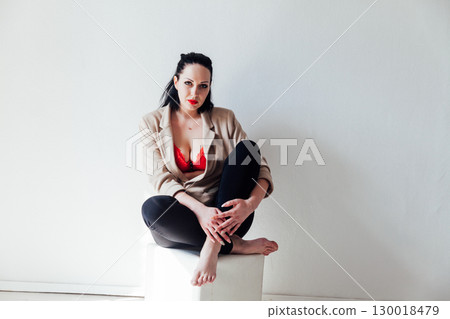woman in jacket and red bra on white background woman in jacket and red bra on white background 130018479