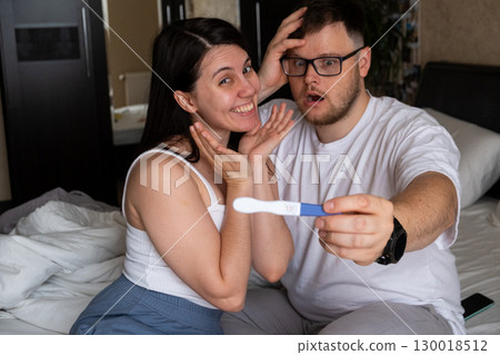 Happy Couple Celebrating Positive Pregnancy Test 130018512