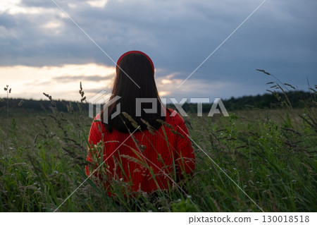 Woman in Red Sweater in Grassy Field 130018518