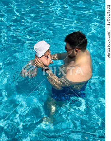 Father and Baby Enjoying Pool Time 130018522