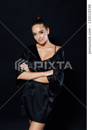 Portrait of a beautiful woman in a black silk robe 130018596