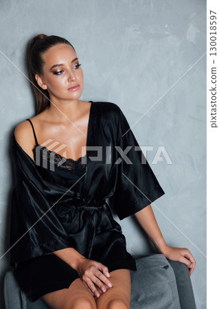 Portrait of a beautiful woman in a black silk robe Portrait of a beautiful woman in a black silk robe 130018597