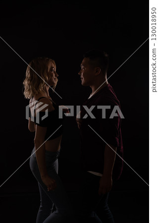 Man and woman dancing to music in the dark 130018950