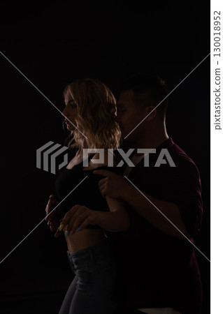 Man and woman dancing to music in the dark Man and woman dancing to music in the dark 130018952