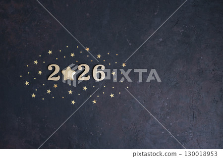 Dark textured background features the golden numbers "2026" with star in place of zero. Ideal for New Year's greetings and holiday marketing, with ample negative space for text 130018953