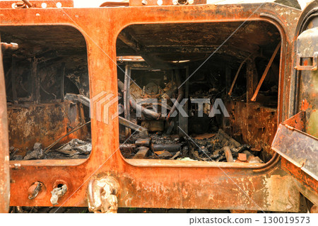 Burned out, rusted and destroyed passenger cabin in military vehicle Burned out, rusted and destroyed passenger cabin in military vehicle 130019573