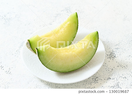 Muskmelon served on a plate 130019687