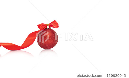 Composition of one red Christmas and New Year ball with red ribbon with reflection on white background 130020043