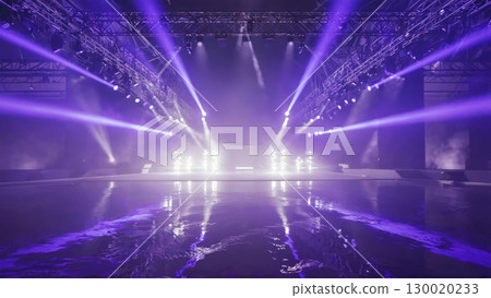 Spectacular light show on stage with reflective floor in concert venue 130020233