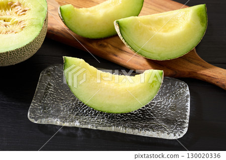 Muskmelon served on a glass plate Muskmelon served on a glass plate 130020336
