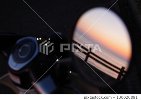 Sunset view through the rearview mirror Sunset view through the rearview mirror 130020881
