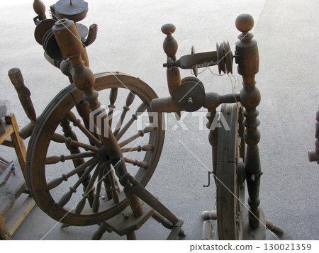 Antique Spinning Wheel in Rustic Workshop Setting with Vintage Tools Nearby Antique Spinning Wheel in Rustic Workshop Setting with Vintage Tools Nearby 130021359