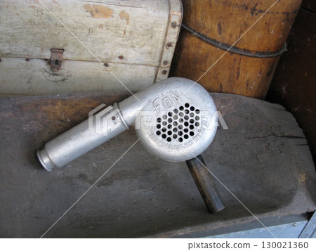 Vintage Metal Blow Dryer with Perforated End in Rustic Storage Area 130021360